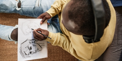 Man Drawing Comic Book Stock Image