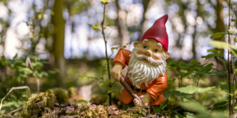 ceramic gnome statue in a forest