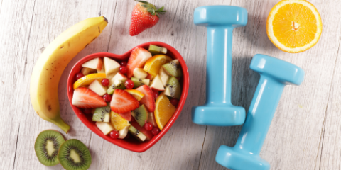 bowl of fruit and two hand weights