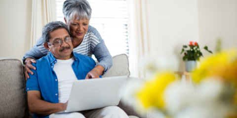 A senior couple looking at a laptop