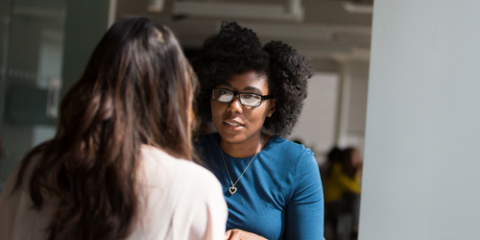 two women having a serious conversation