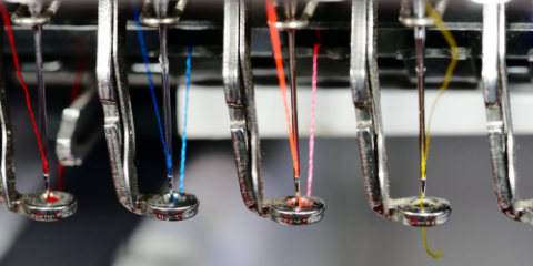 close up of embroidery machine needles