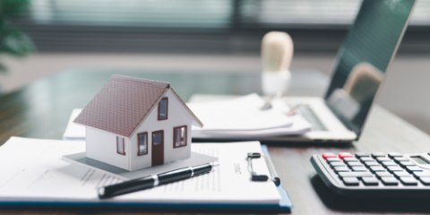 image of a tiny house on tax papers