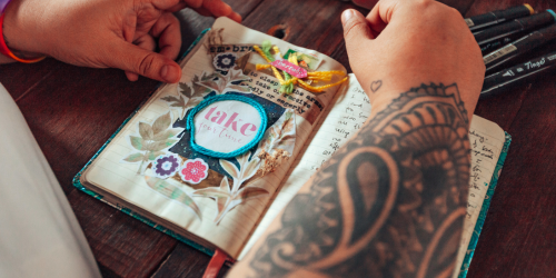 woman assembling a junk journal