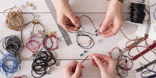 hands making jewelry