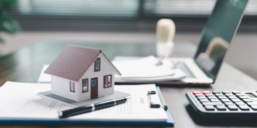 image of a tiny house on tax papers