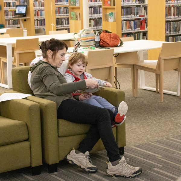 Adult and child reading at the Ashtabula Library.